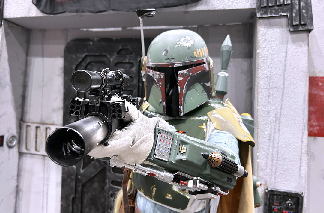 A cosplayer dressed as Boba Fett holding a blaster during MegaCon 2026.